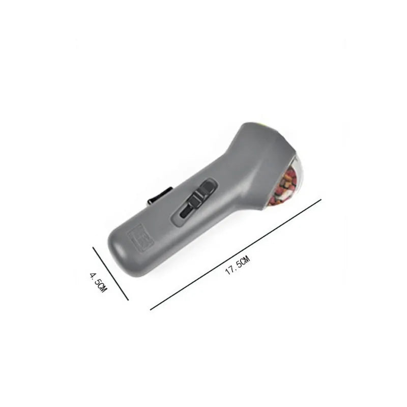 Grey plastic pet snack launcher toy with spring trigger mechanism for treat dispensing
