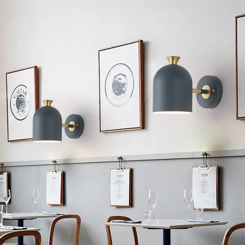 Blue aluminium single-head LED wall lamp mounted beside a bed.