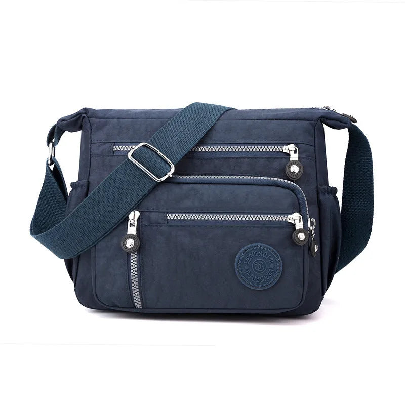 Nylon messenger bag in square vertical shape with single shoulder strap, shown in one of five colour options