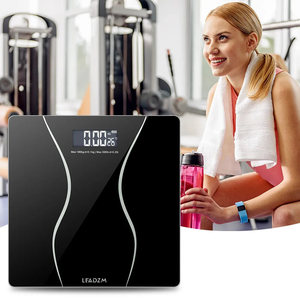 Black electronic bathroom scale with digital display showing weight measurement