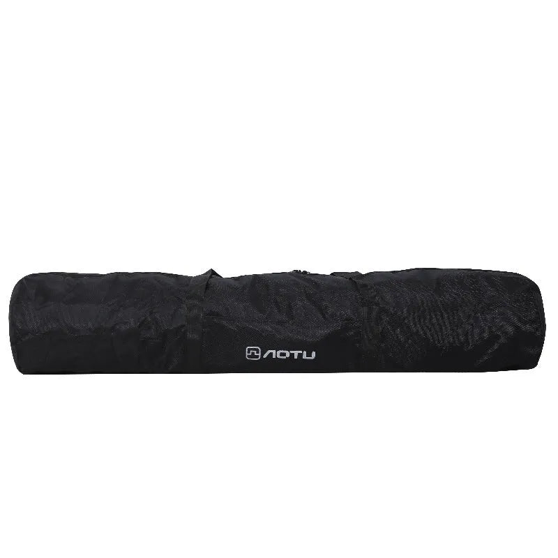 Green waterproof camping storage bag with carry handles, shown carrying a folding table and chairs.