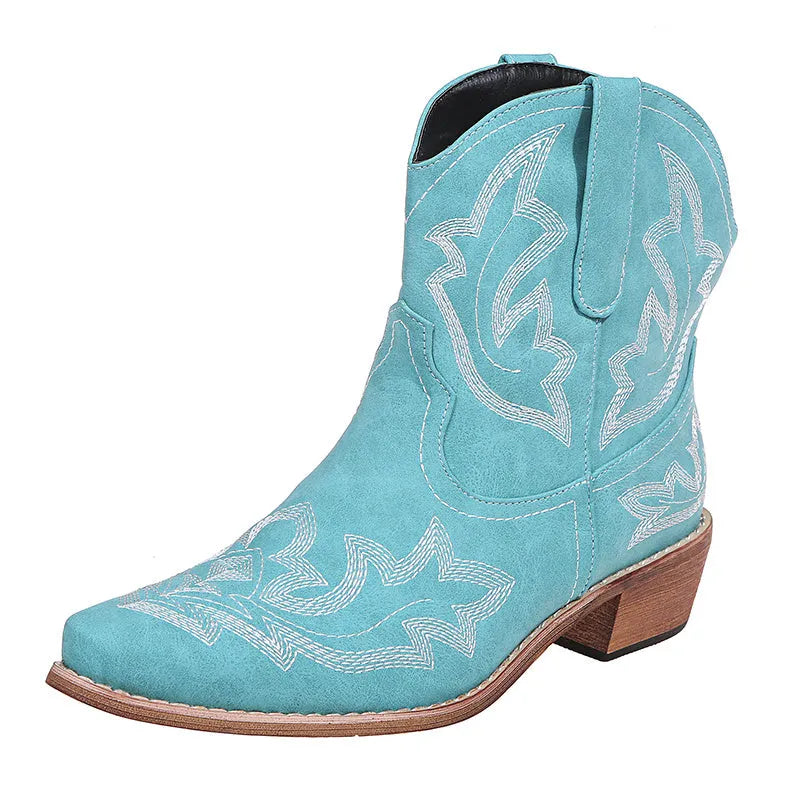 Women's blue embroidered cowboy boots with low wedge heel and pointed toe on a white background.