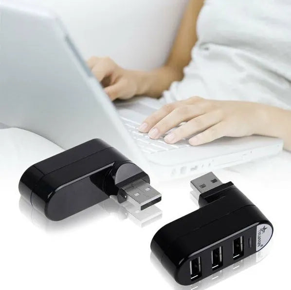 Black and white 4-port USB 2.0 splitter hub shown next to a laptop