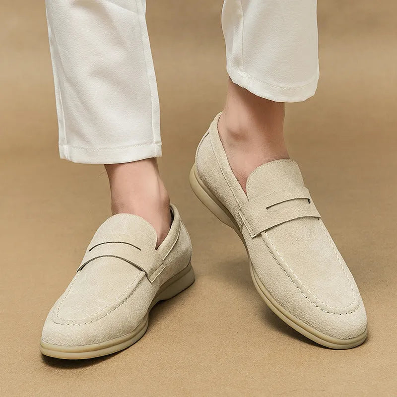 Men's beige leather slip-on casual shoes with a round toe and rubber sole.