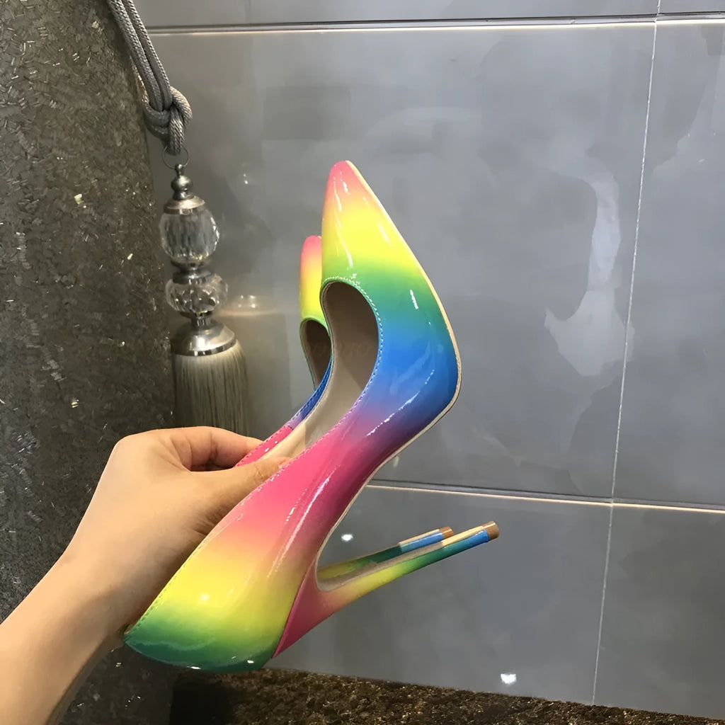 Rainbow coloured patent leather women's high heel shoe with pointed toe and thin high heel.