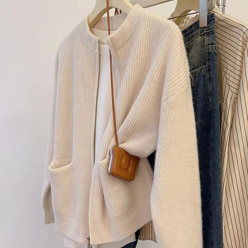 Beige viscose women's sweater coat cardigan with long sleeves laid flat.