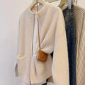Beige viscose women's sweater coat cardigan with long sleeves laid flat.