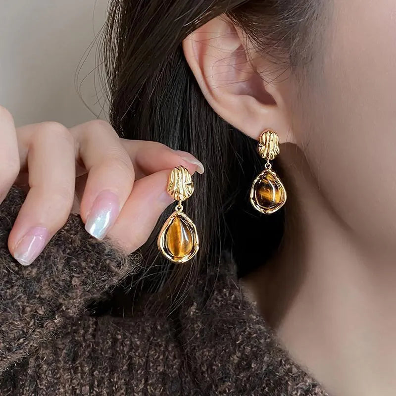 Three pairs of geometric alloy ear rings with tassel elements in different electroplated finishes