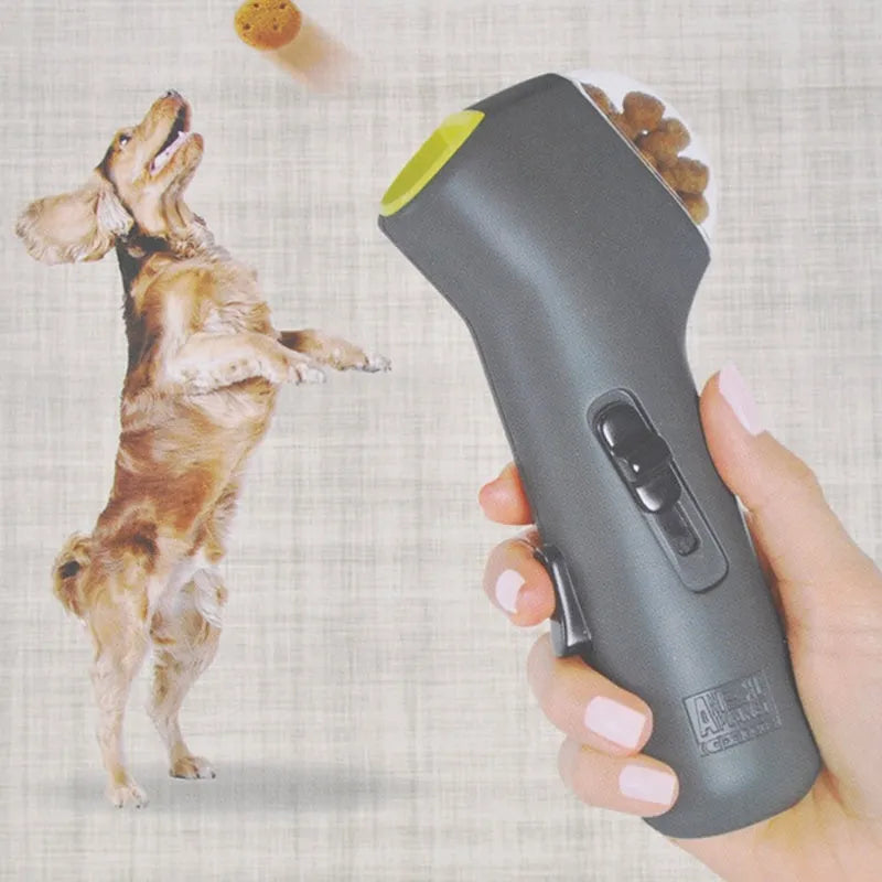 Grey plastic pet snack launcher toy with spring trigger mechanism for treat dispensing