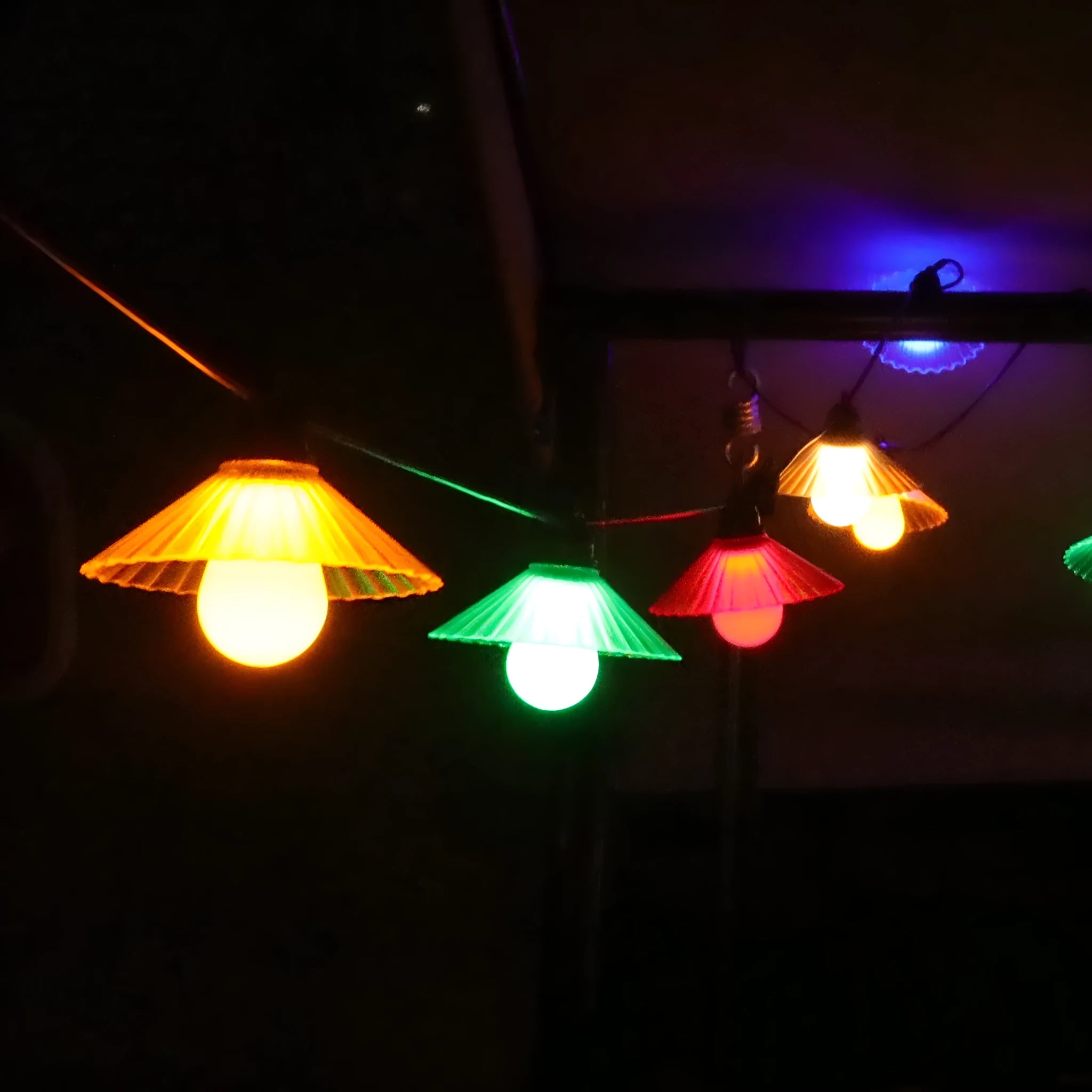 Outdoor LED string lights with flower-shaped bulbs in warm white and colour options.