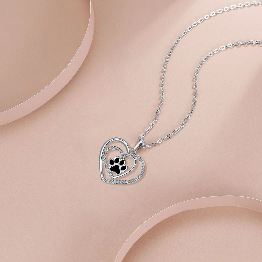 Women's copper necklace with heart-shaped dog paw print pendant on a cross chain