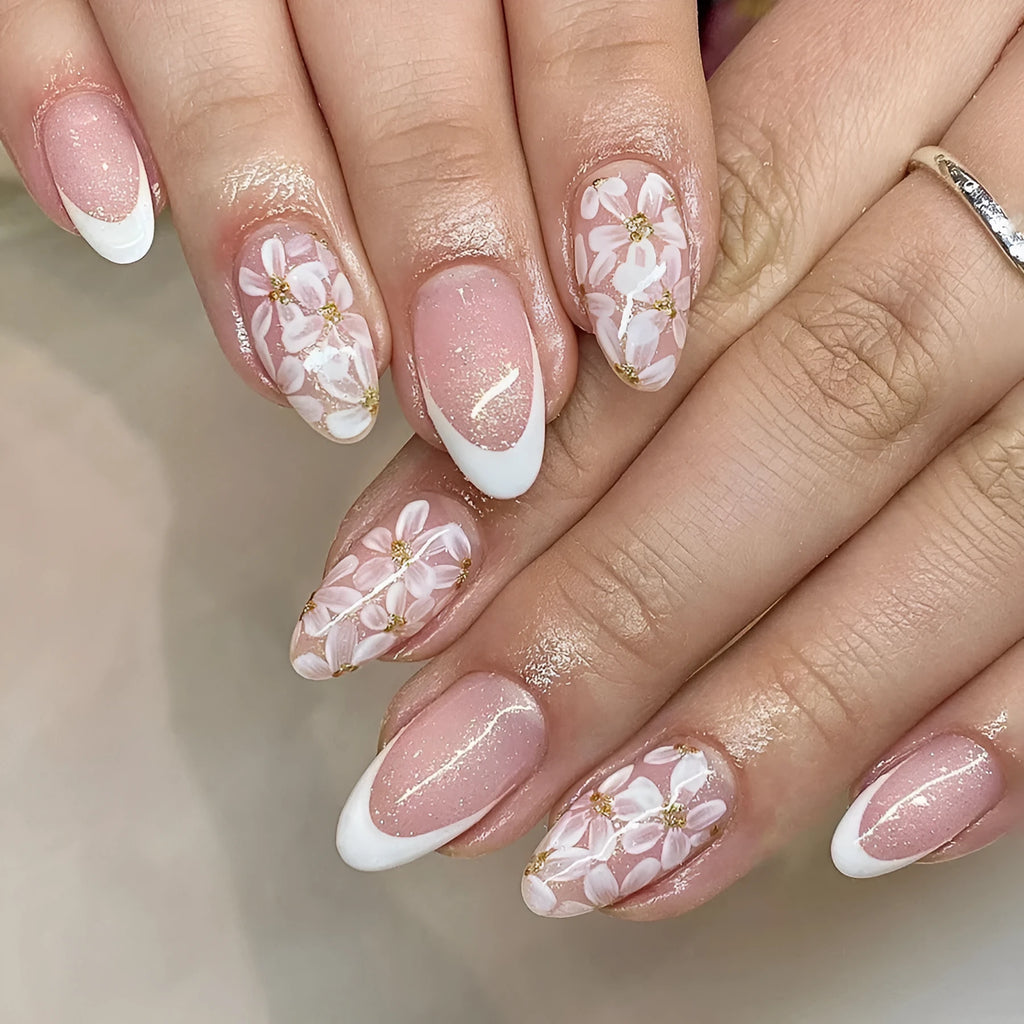Short almond artificial nails with French style glitter flower decoration in C625 colour
