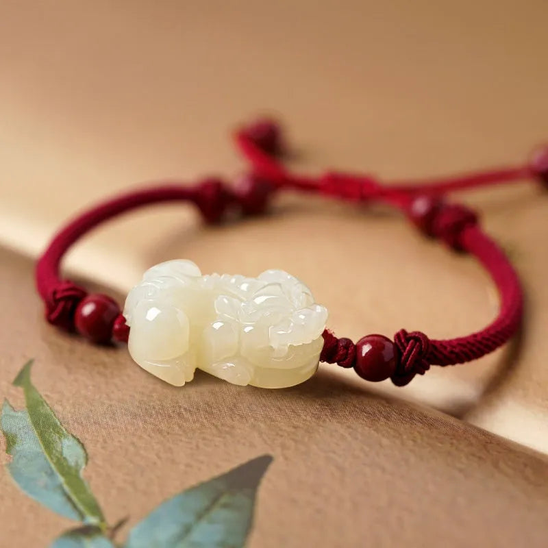 Hetian Jade bracelet with a black and red braided rope band and a central jade bead.