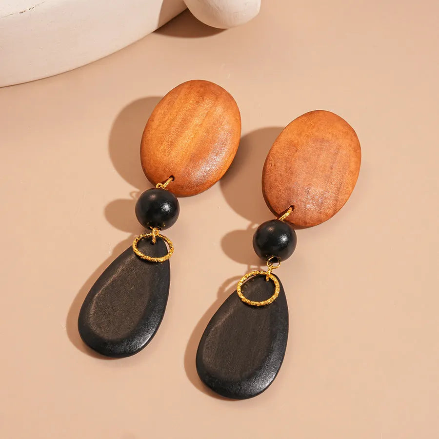 Handcrafted wooden ellipse earrings in silver brown black colours with retro European American style