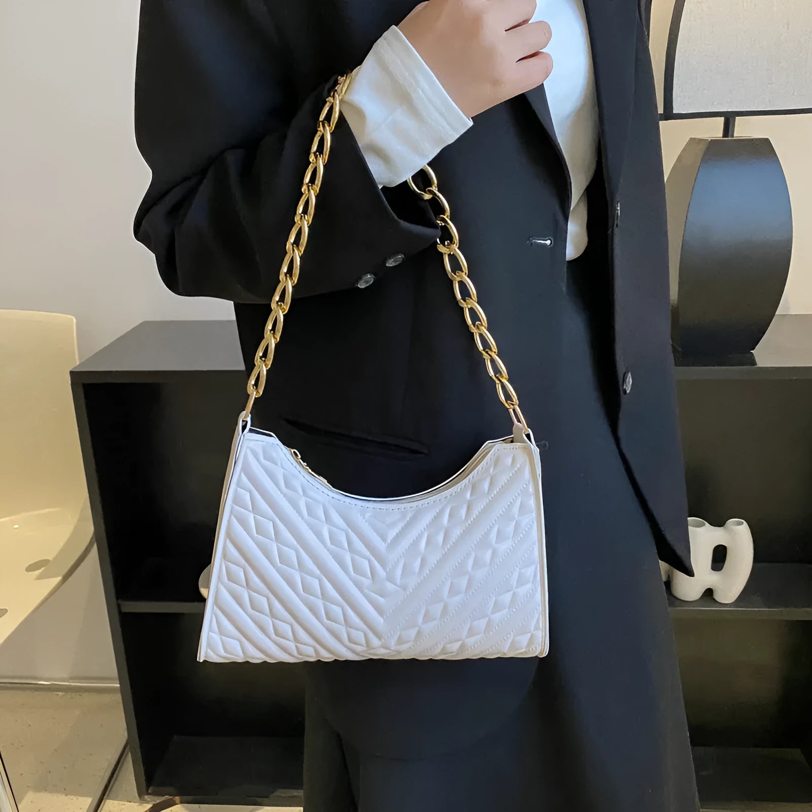 Brown pleated chain baguette shoulder bag showing vertical square shape and adjustable 50cm strap