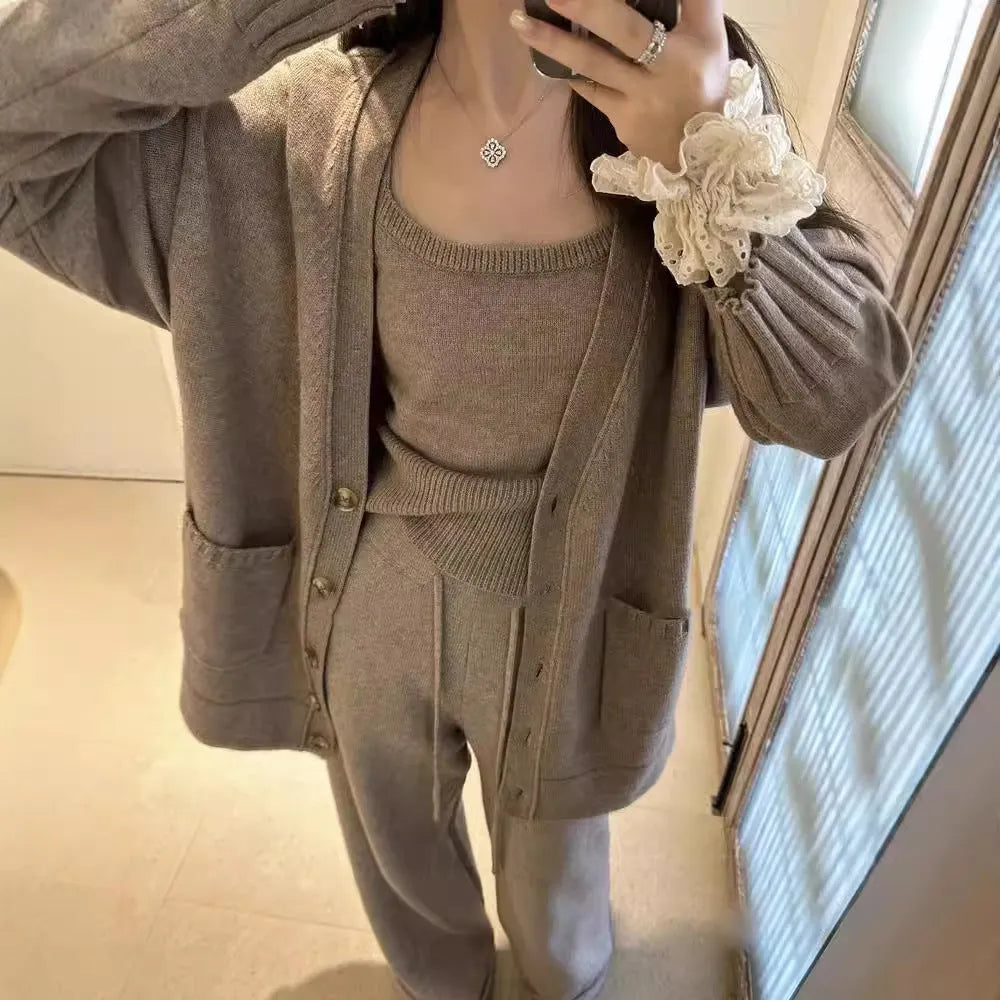 Women's loose fit knit cardigan, vest, and casual pants three-piece set in a solid colour.