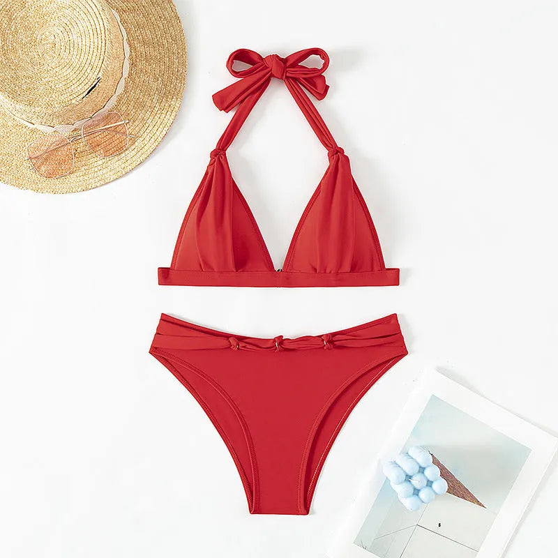 Women's red lace-up halterneck bikini set with split design and matching shorts for swimming