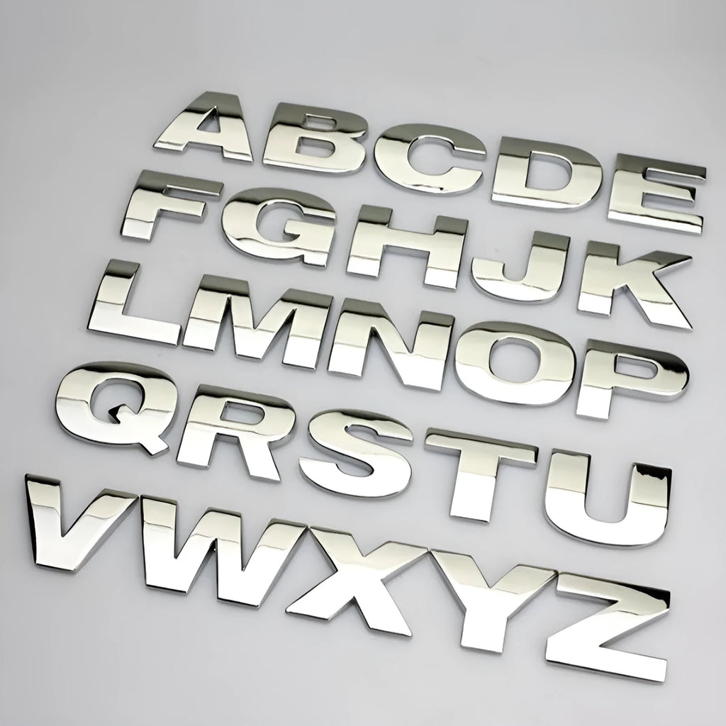 Close-up of a 3D metal zinc alloy letter 'A' car bumper sticker in silver finish.