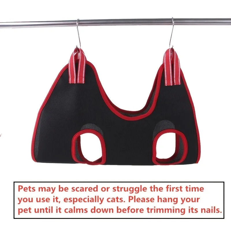 A suspended pet grooming hammock restraint bag in use, showing a small dog being groomed.