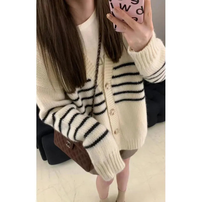 Collar button cardigan in pictured colour with 3D effect polyester fabric.