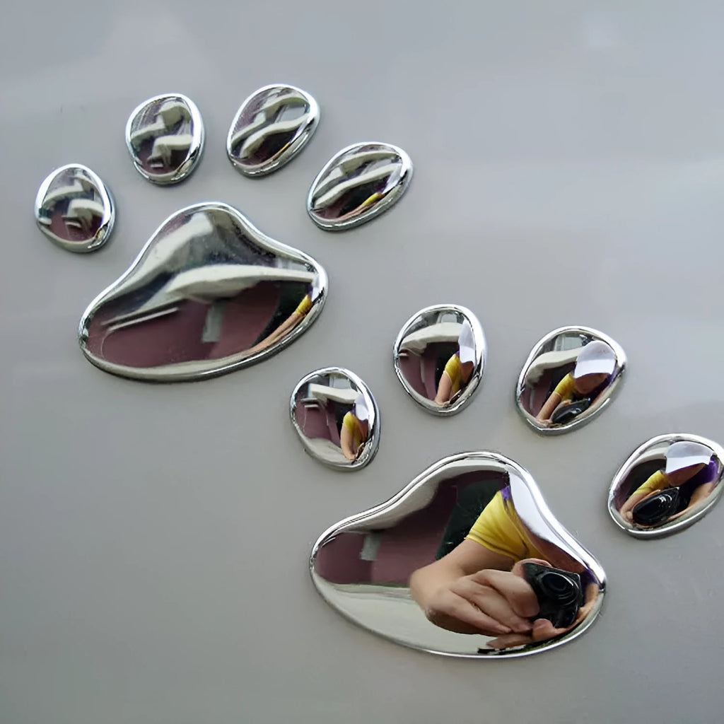 Pair of hand-shaped brush dog footprint PVC car stickers in red, shown against a car bumper.