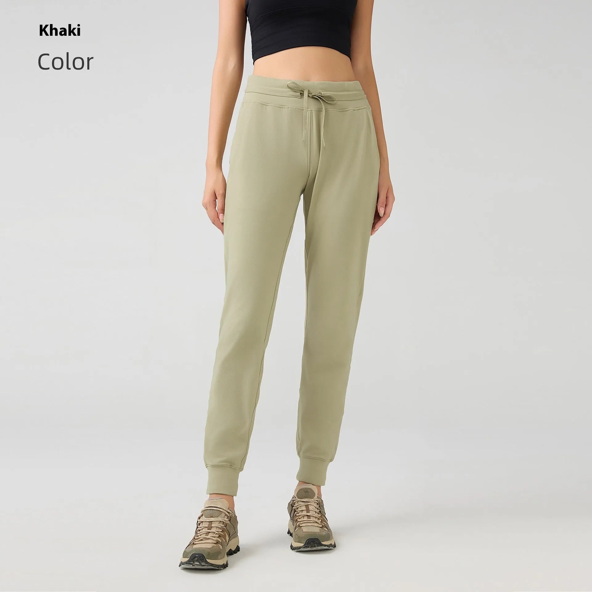 Women's high-waist yoga pants with drawstring waistband in a cotton blend fabric.