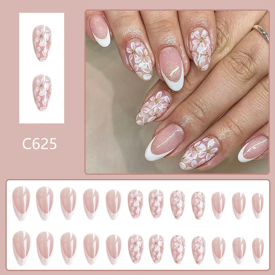Short almond artificial nails with French style glitter flower decoration in C625 colour