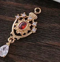 Water drop pendant with zircon crown detail in copper with electroplated finish.