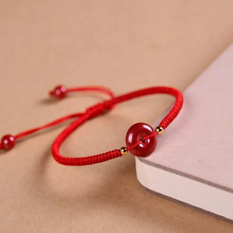 Cinnabar safety buckle bracelet with heart-shaped pendant on adjustable rope cord