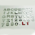 Close-up of a 3D metal zinc alloy letter 'A' car bumper sticker in silver finish.