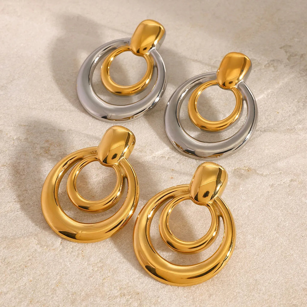 Round double layer hollow stud earrings with gold electroplated surface on titanium steel