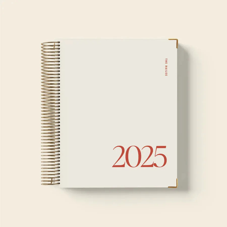 Cherry Red coil notebook open to show daily schedule pages and wire-bound spine