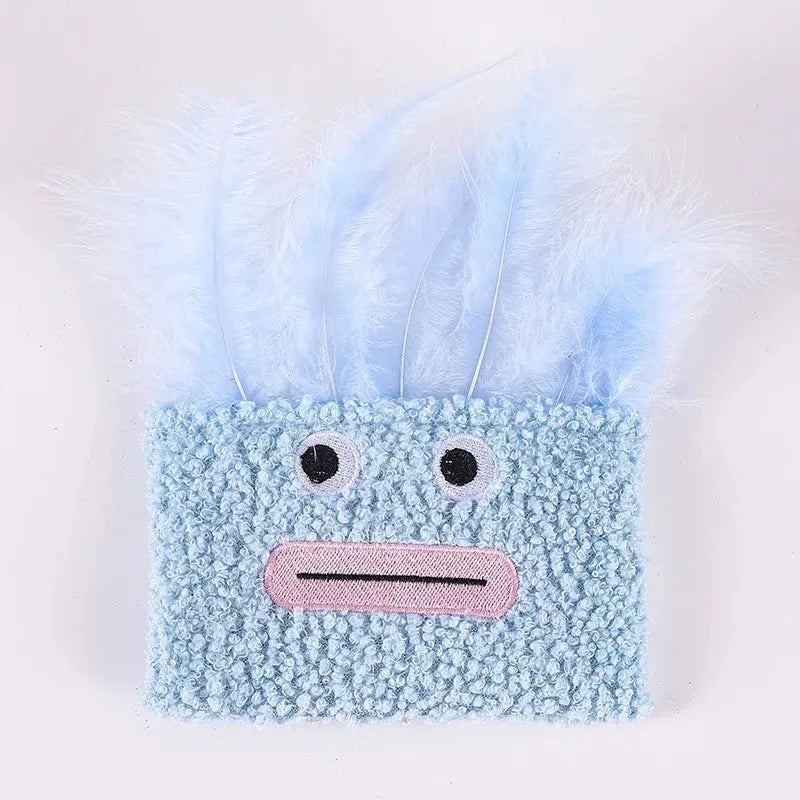 Colourful cat plush toy with a big mouth explosion head shape on a plain background.