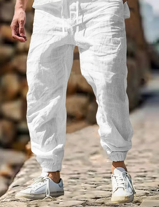 Men's straight-leg linen trousers in apricot colour with an elasticated waistband.