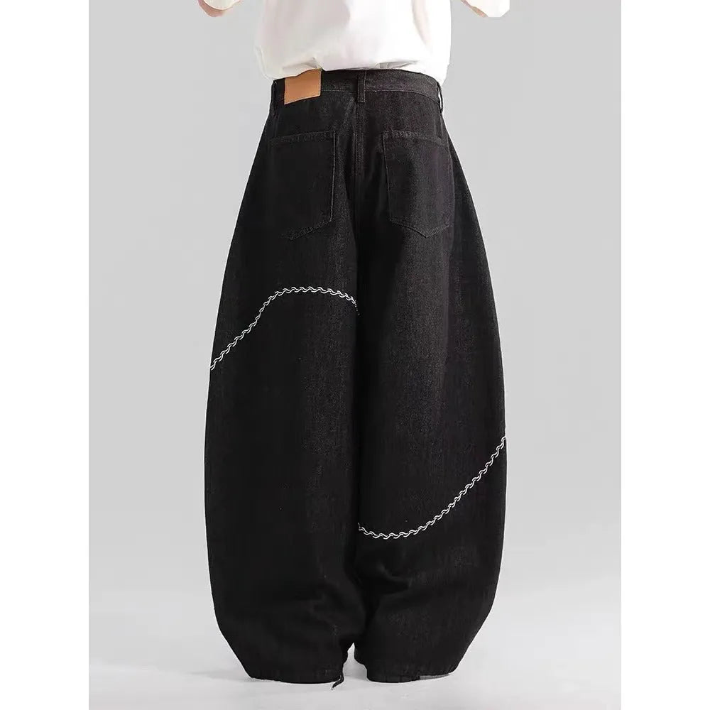 Men's black straight-leg jeans with a mid waist and zip fly, shown laid flat.