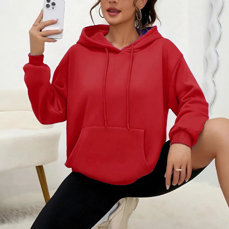 A loose-fitting women's long-sleeve sweatshirt with a drawstring pocket, shown in a solid colour.