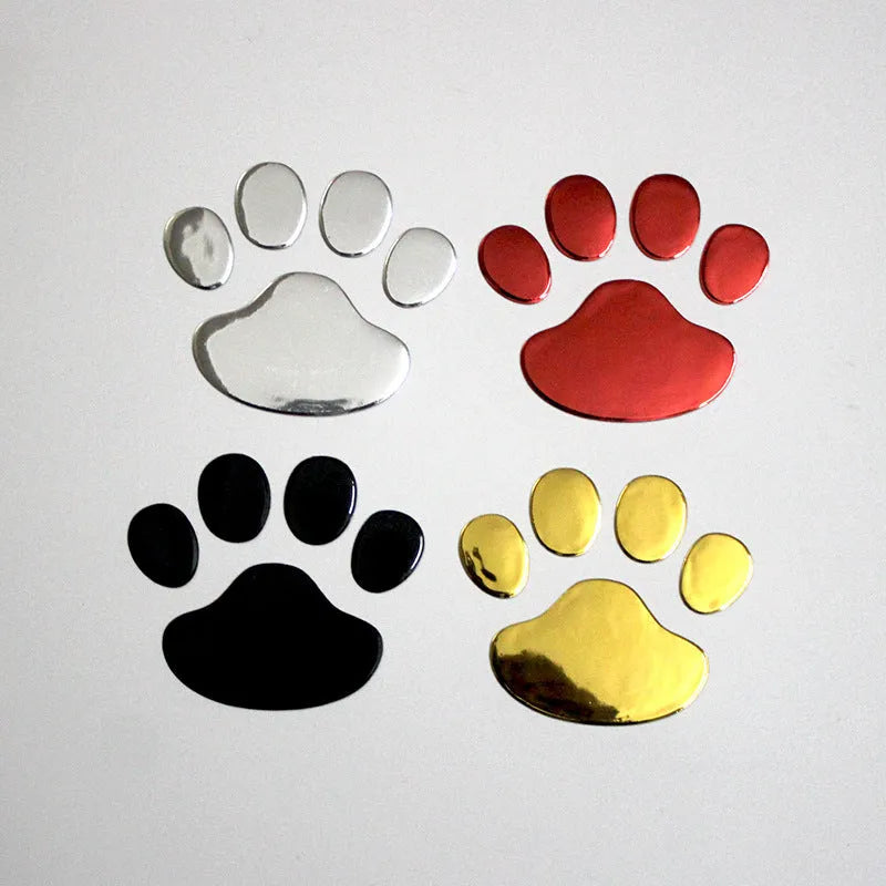 Pair of hand-shaped brush dog footprint PVC car stickers in red, shown against a car bumper.