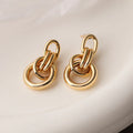 Geometric irregular-shaped copper earrings for women with a real gold colour finish.