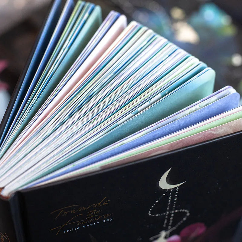 A5 notebook with a luminous cover in one of four colours, open to show pages with colour illustrations