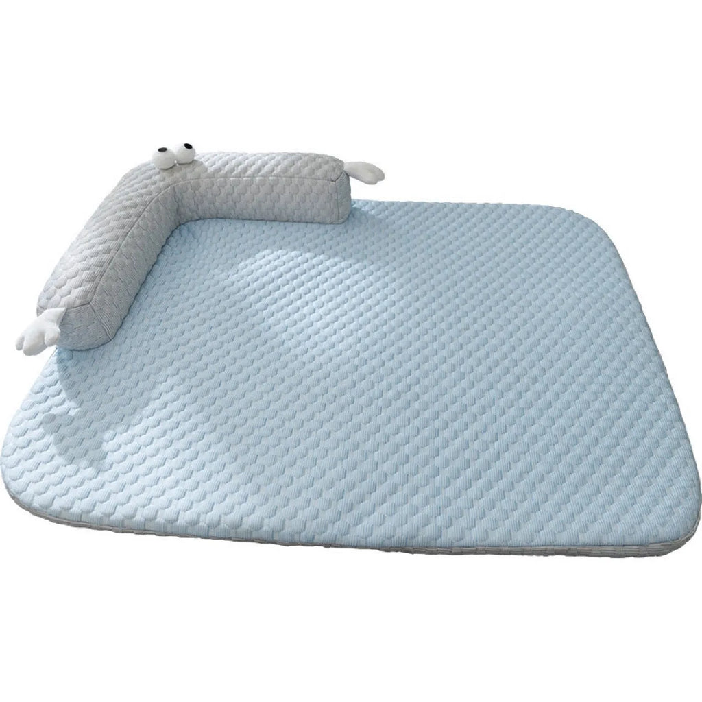 Blue polyester pet bed cushion with printed big-eyed monster face design, shown on a wooden floor.