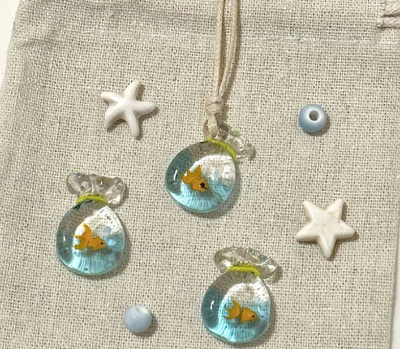 Women's necklace with Small Fish Lucky Bag glaze pendant on a cotton linen chain.