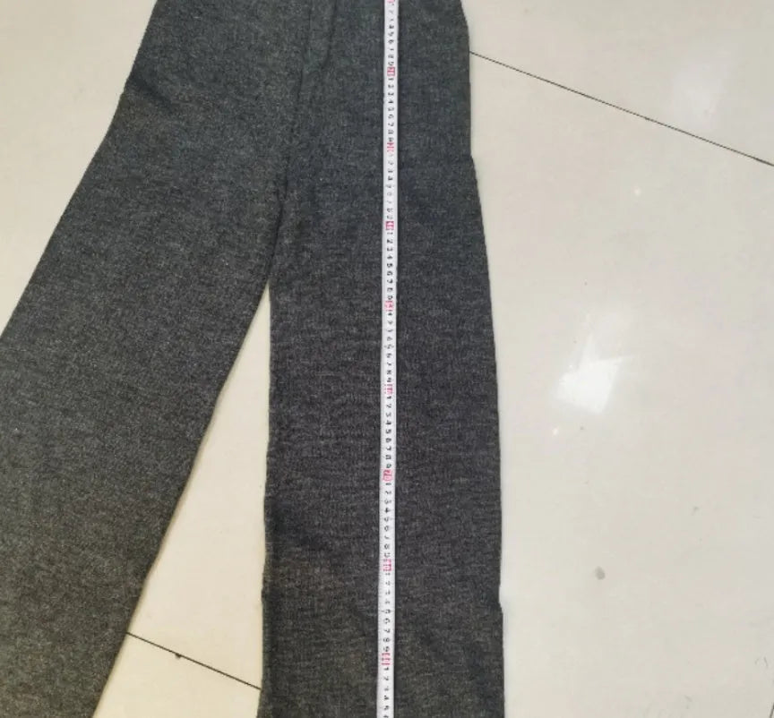 Women's dark grey side-slit sweater and trousers suit set on a hanger