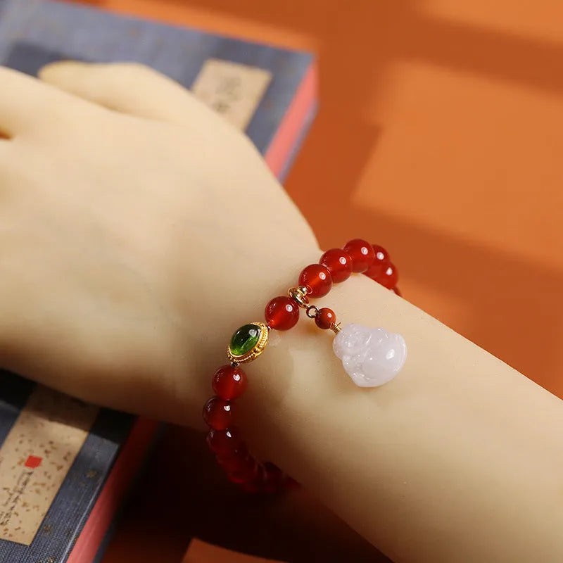 Handmade women's bracelet with red agate and amber Maitreya Buddha pendant.