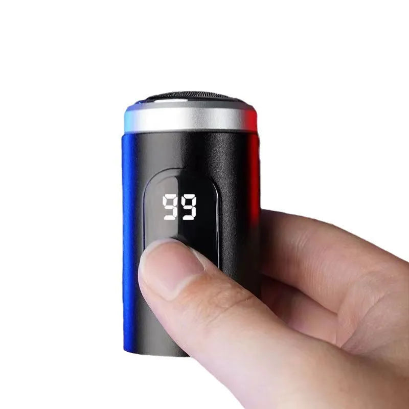 Black portable USB rechargeable shaver with cleaning brush and cable on a white background.