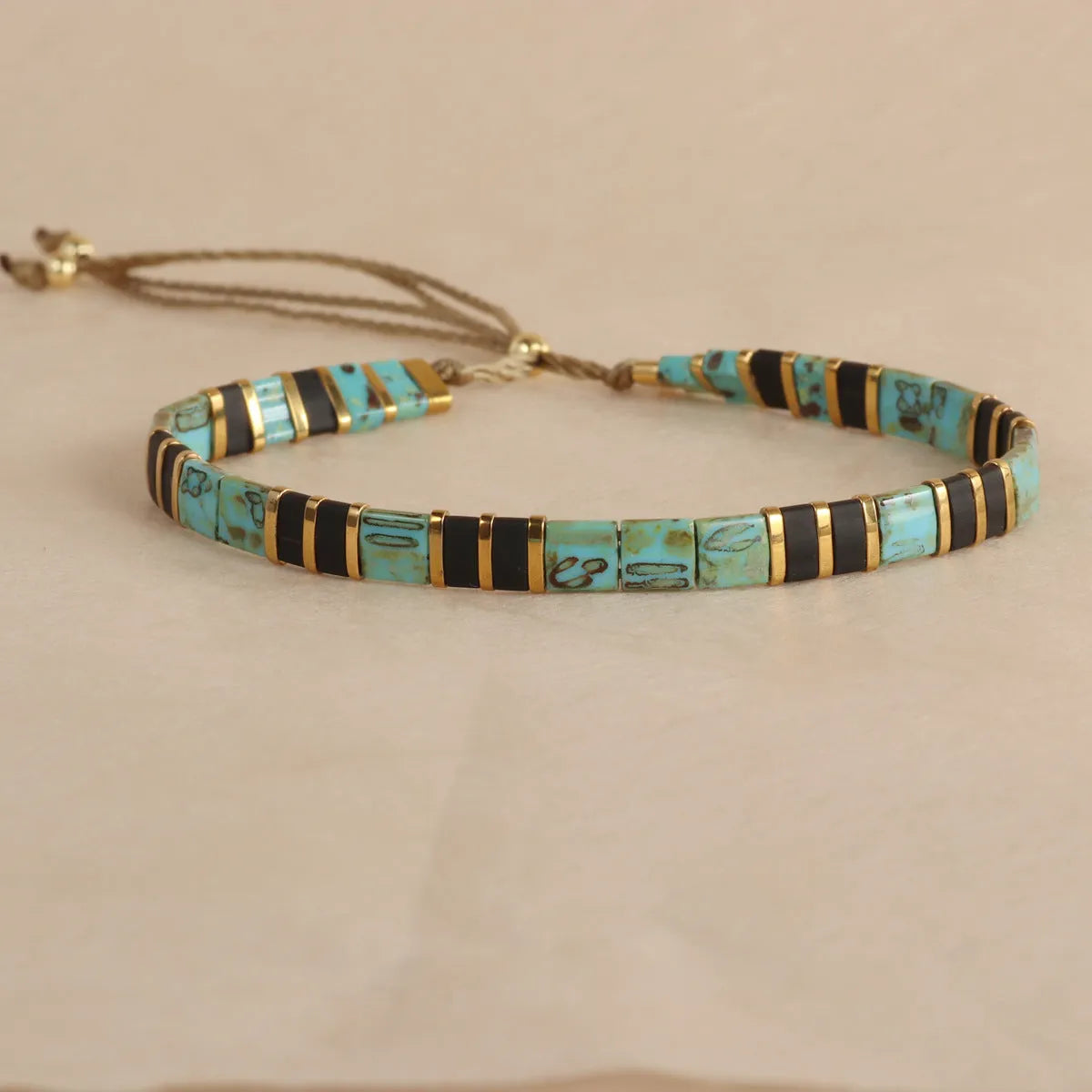 Geometric pull bead bracelet with round glass beads in multiple colour options.