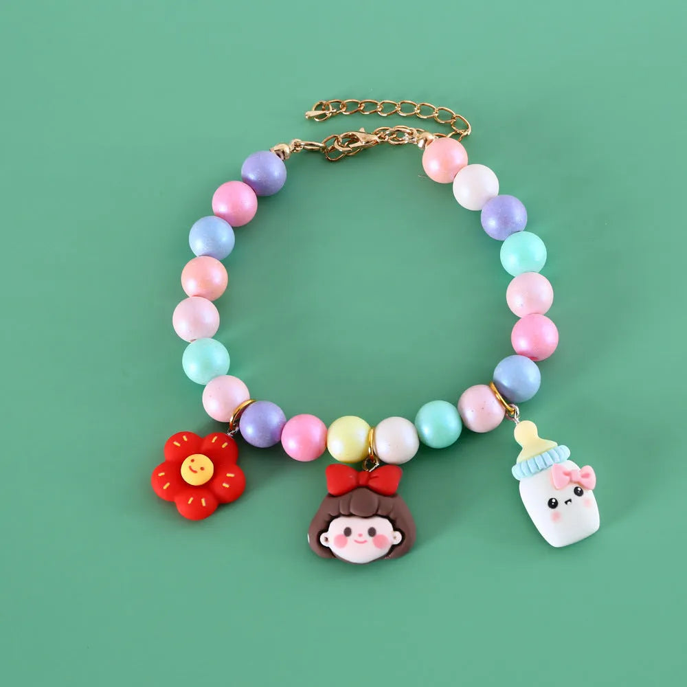 Macaron-colour pet collar with moon and pearl resin charms and a matching bracelet.