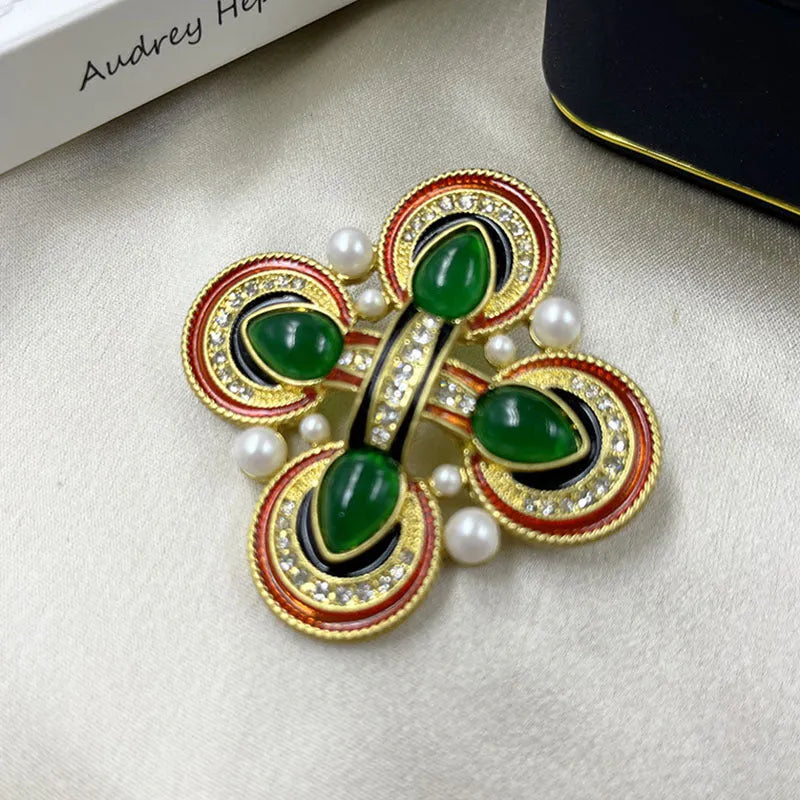 Close-up of vintage medieval baroque cross brooch with crystal details on zinc alloy base