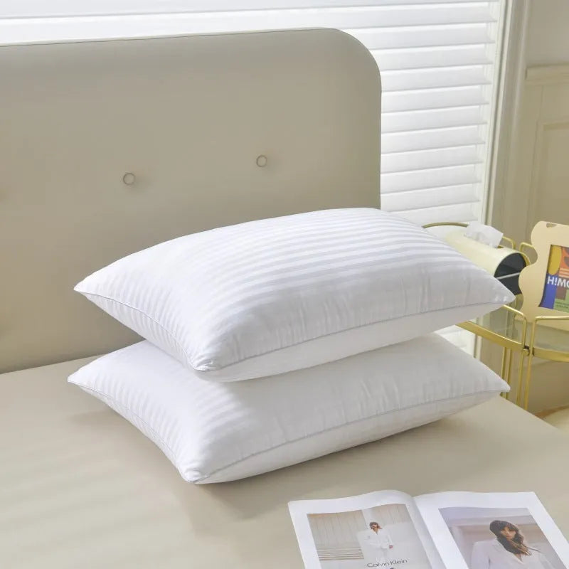 White hotel cotton satin stripe pillow with feather and cotton filling on a bed.