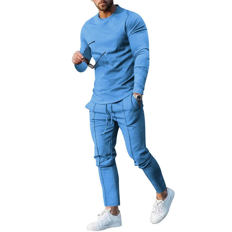 Men's light grey polyester two-piece suit with long sleeve round neck T-shirt and matching trousers laid flat.