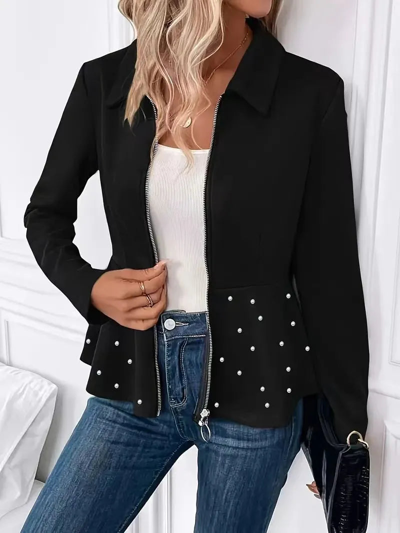 Women's loose black coat with beaded zipper and ruffled hem, shown on a hanger.